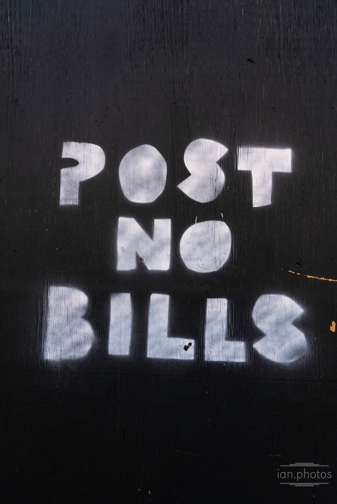 "POST NO BILLS" crudely sprayed onto a wood barrier | ian.photos