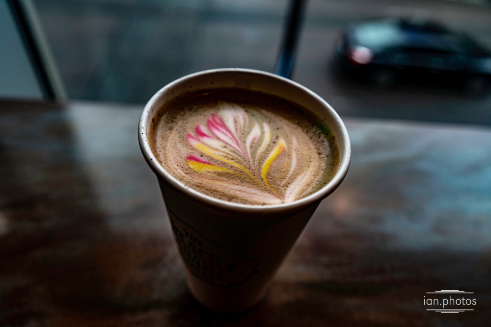 Latte with colourful art design on the coffee. 